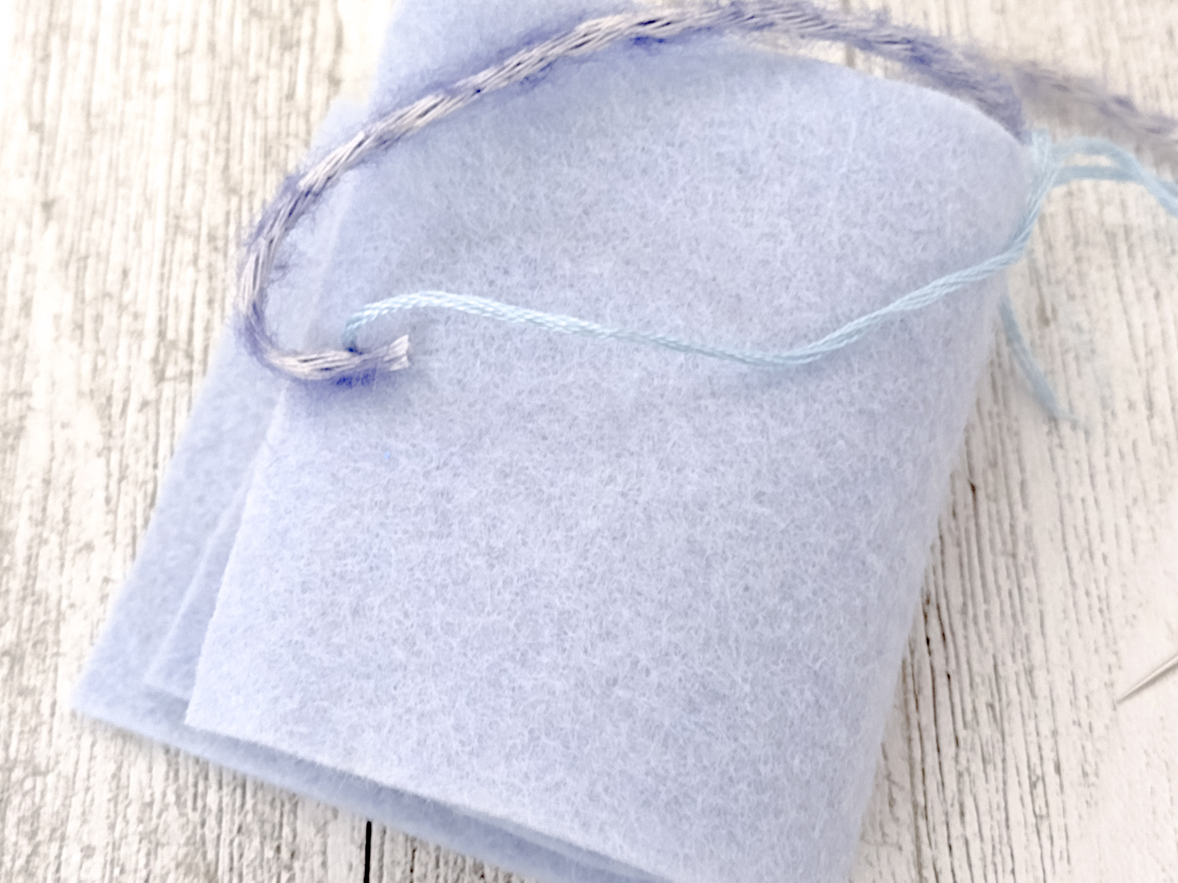 Sew on the yarn to the simple needle book