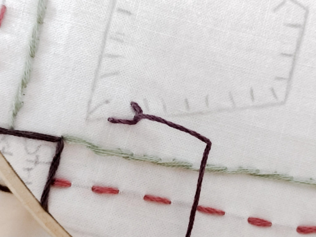 L shaped stitch wich is the start of the blanket stitch, pencil pattern marks seen on an embroidery sampler