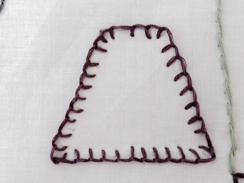 Blanket stitch in purple embroidery floss shaped like a simple long skirt.