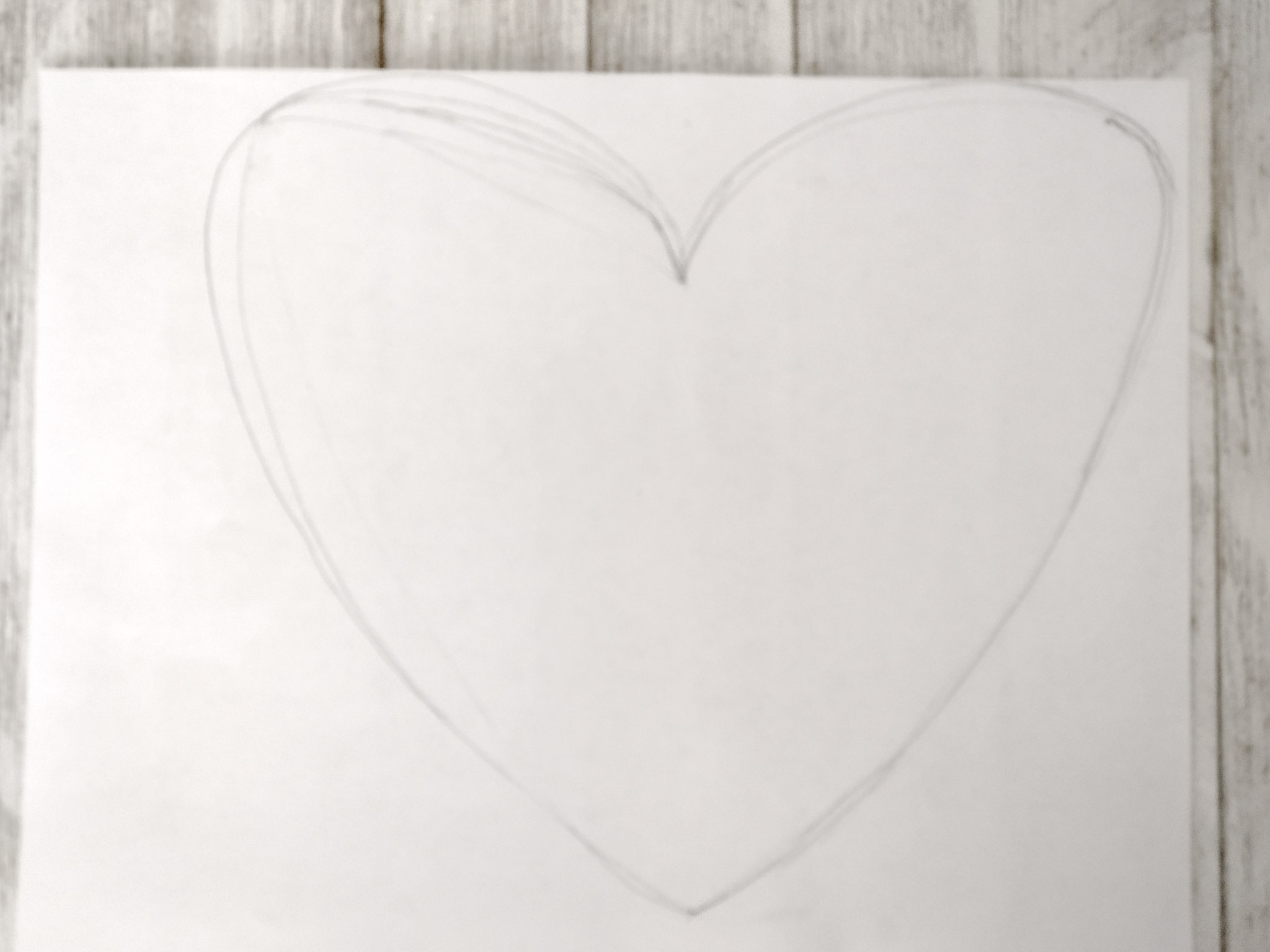 paper with pencil drawing of a heart