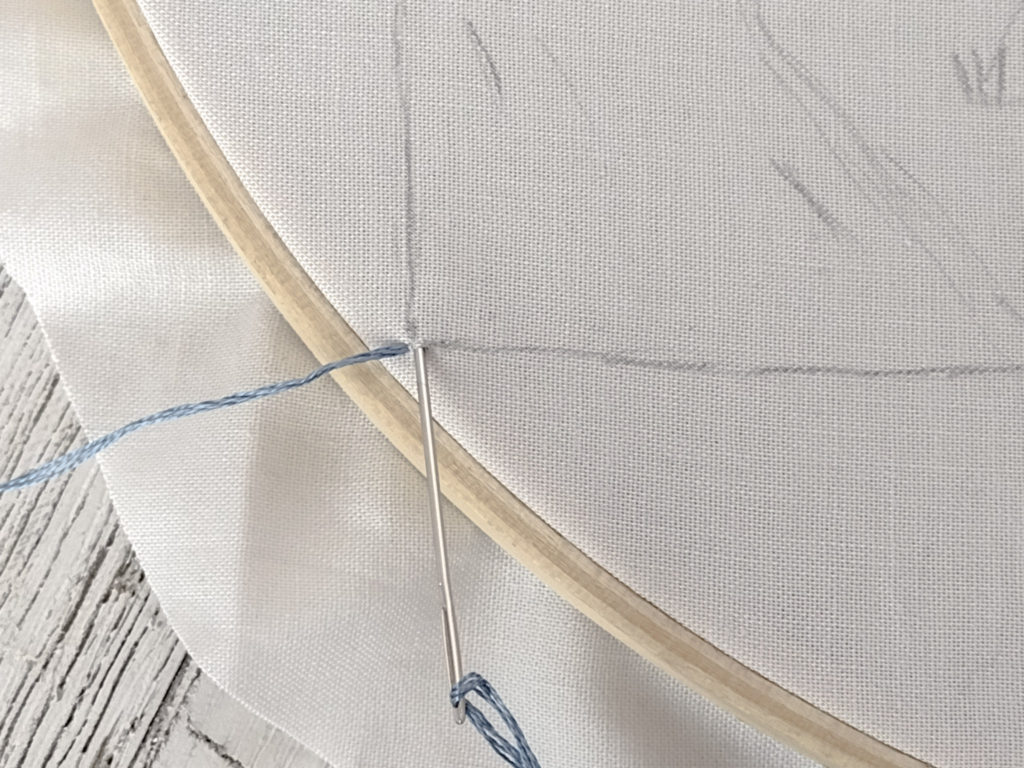 Embroidery needle pull up for beginning a stitch