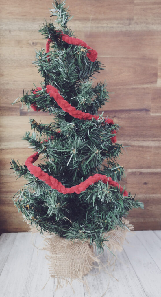 Cute mini Christmas tree with red yarn finger knitted Christmas garland. Great finger knitted gift.
